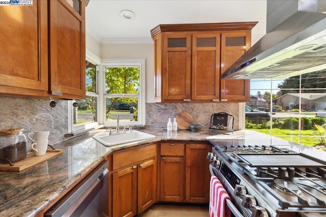 kitchen featuring wall chimney range hood, stainless steel appliances, sink, backsplash, and crown molding