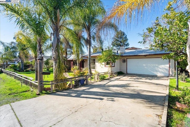 single story home featuring a front lawn and a garage