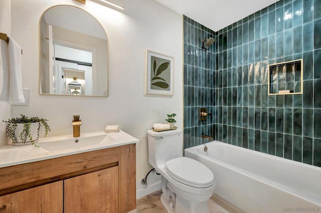 full bathroom featuring vanity, tiled shower / bath, and toilet