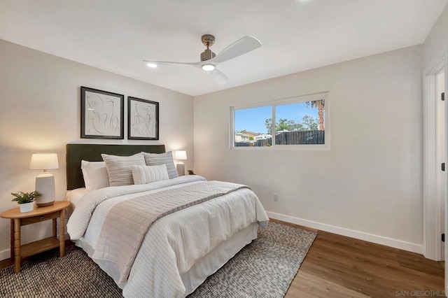 bedroom with ceiling fan and dark wood-type flooring