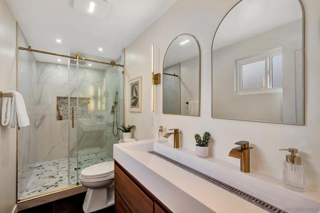 bathroom with vanity, an enclosed shower, and toilet