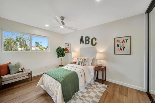 bedroom with ceiling fan and light wood-type flooring