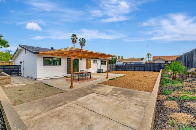 back of property featuring a pergola and a patio