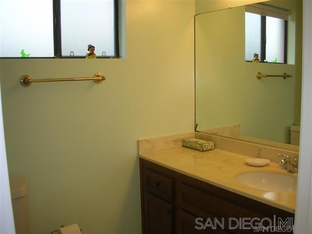 bathroom featuring toilet, a healthy amount of sunlight, and vanity