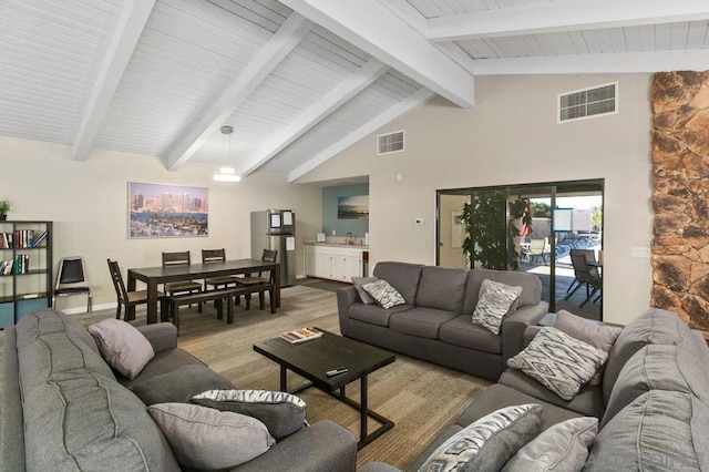 living room featuring light hardwood / wood-style floors, sink, and lofted ceiling with beams