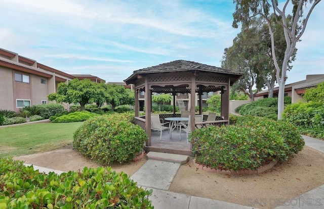 view of property's community with a lawn, a gazebo, and a patio area