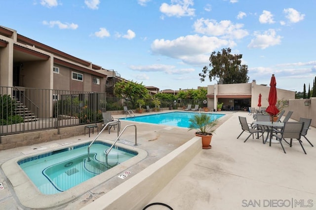 view of swimming pool with a community hot tub and a patio