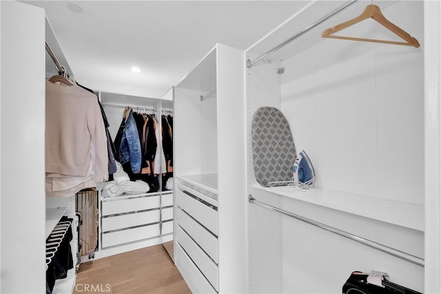 walk in closet with light wood-type flooring