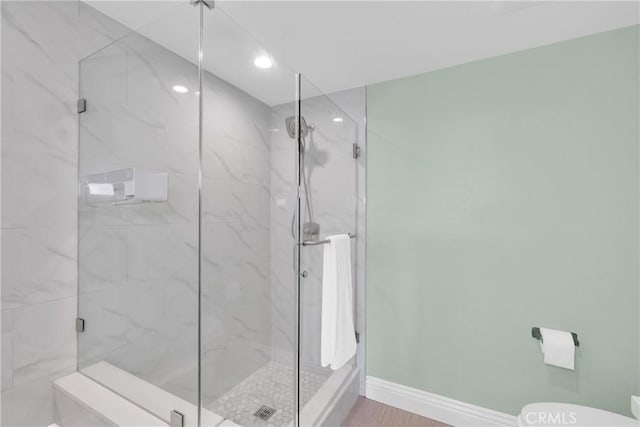 bathroom featuring hardwood / wood-style floors, toilet, and walk in shower