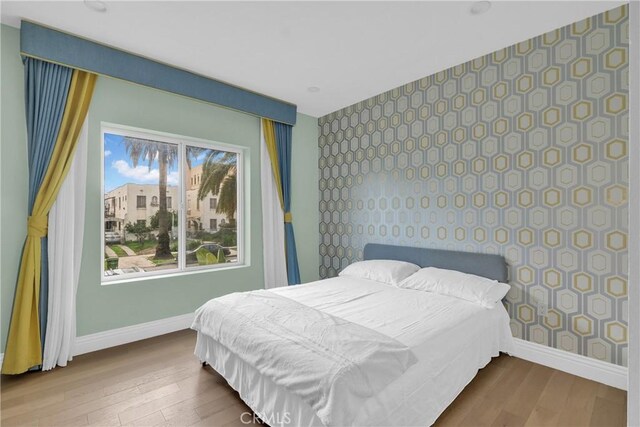 bedroom with wood-type flooring