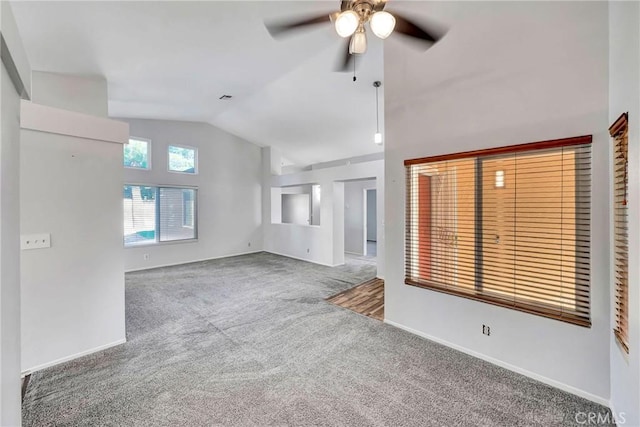 unfurnished living room featuring ceiling fan, lofted ceiling, and carpet flooring