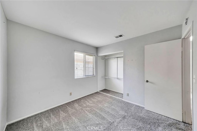 unfurnished bedroom featuring a closet and carpet