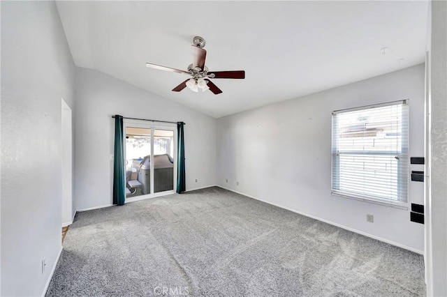 carpeted empty room with ceiling fan and vaulted ceiling