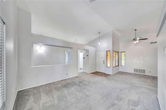 empty room with ceiling fan, high vaulted ceiling, and carpet floors