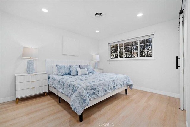 bedroom with light hardwood / wood-style floors