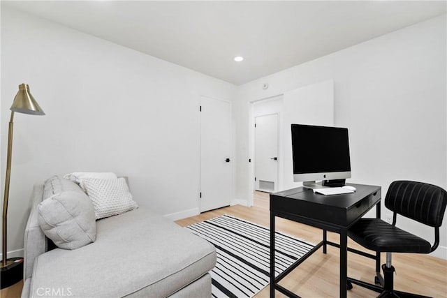 home office with hardwood / wood-style flooring