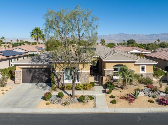 view of front facade featuring a mountain view and a garage