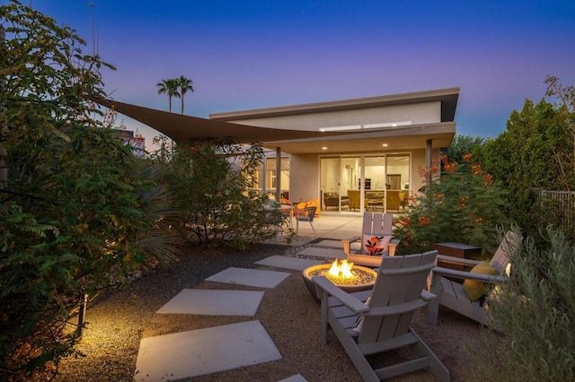 patio terrace at dusk with a fire pit