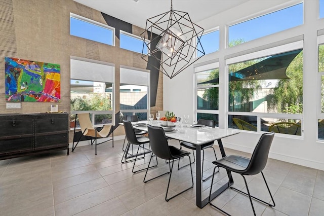 dining room featuring light tile patterned floors, a chandelier, and plenty of natural light