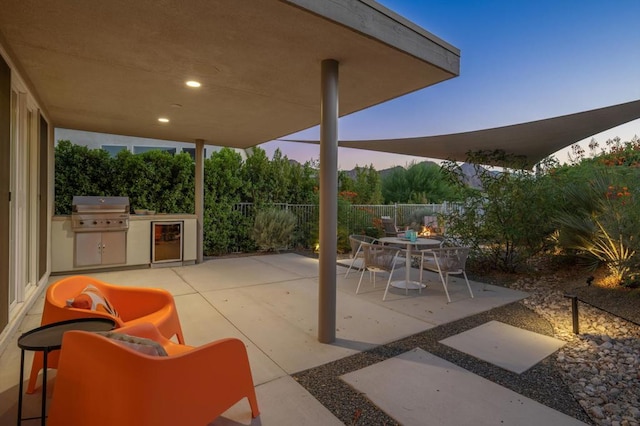 patio terrace at dusk with area for grilling