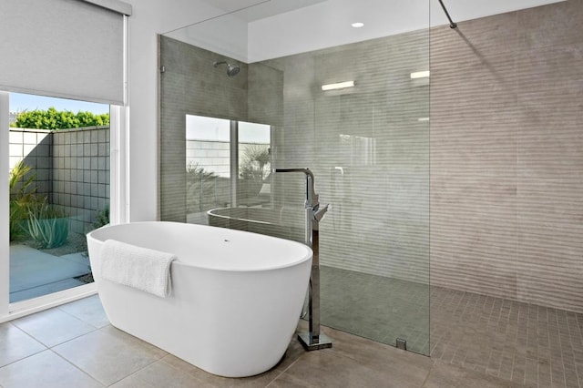 bathroom featuring separate shower and tub and tile patterned flooring