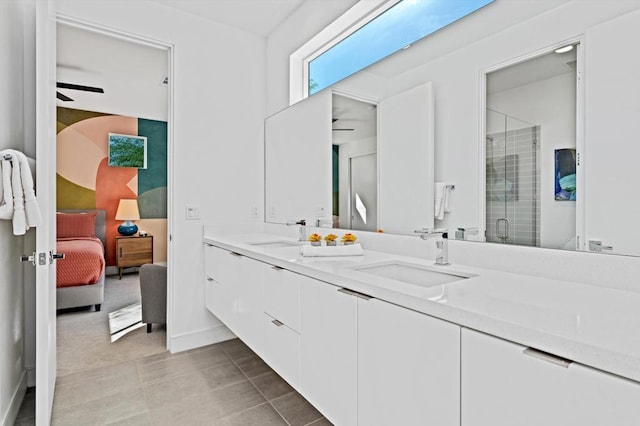 bathroom featuring walk in shower, vanity, ceiling fan, and tile patterned flooring