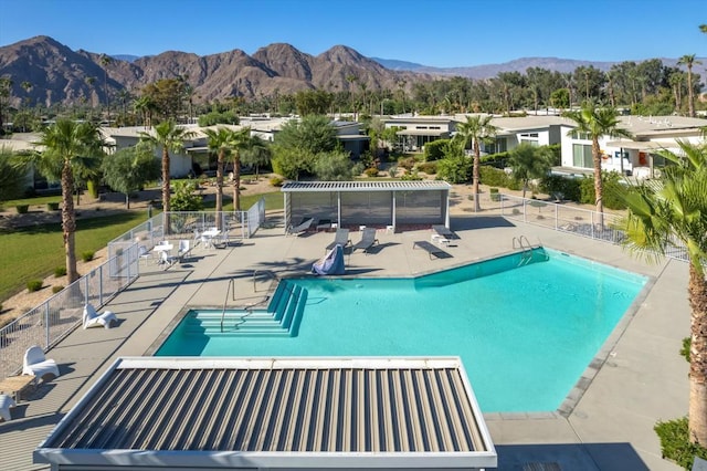 view of swimming pool featuring a mountain view and a patio