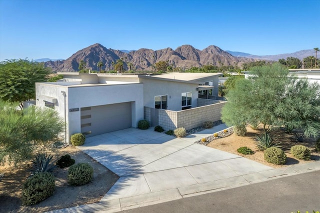 view of front of house featuring a garage and a mountain view