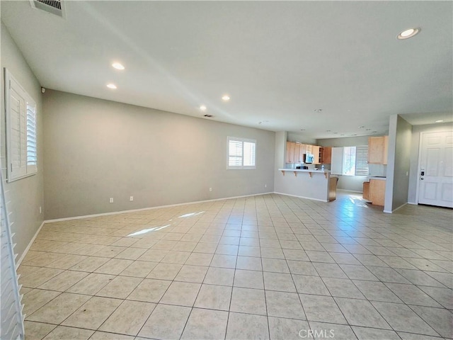 unfurnished living room featuring light tile patterned floors