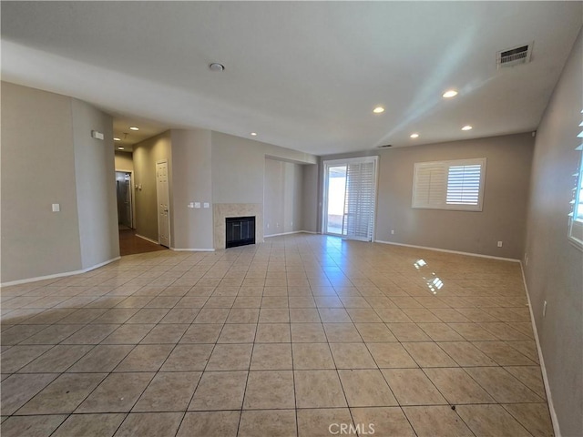 unfurnished living room featuring light tile patterned floors and a fireplace