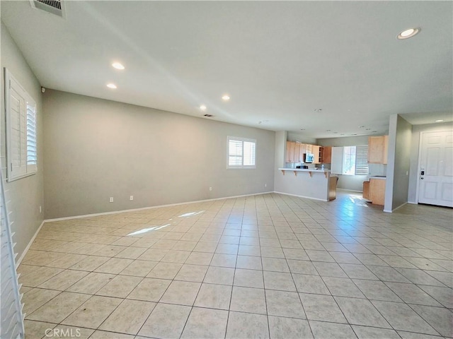 unfurnished living room with light tile patterned floors