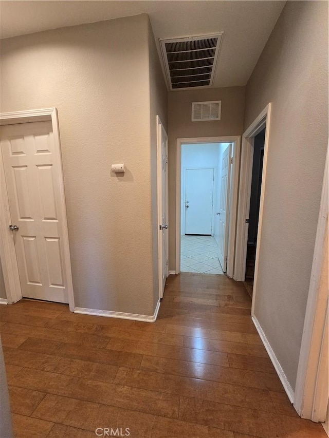 corridor featuring dark hardwood / wood-style flooring