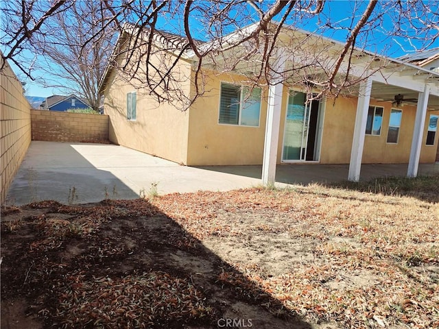 back of property featuring a patio area and ceiling fan