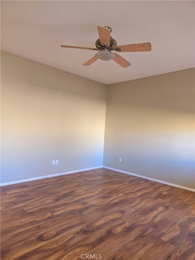 empty room with dark hardwood / wood-style floors and ceiling fan