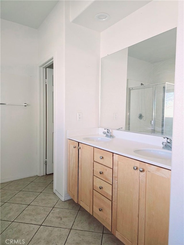 bathroom featuring vanity, tile patterned floors, and walk in shower