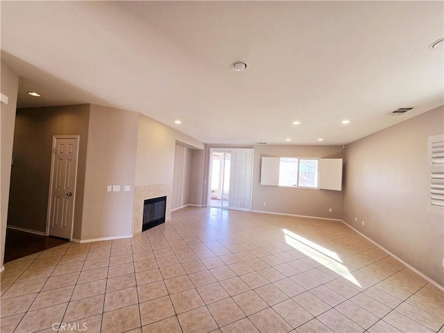 unfurnished living room featuring a fireplace and light tile patterned flooring