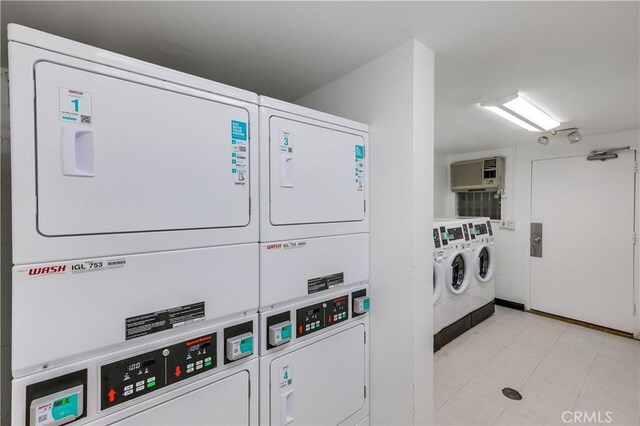 clothes washing area featuring washer and clothes dryer and stacked washer / drying machine