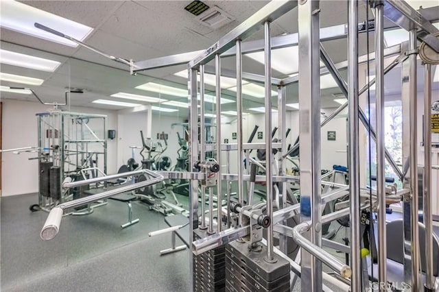 workout area with a paneled ceiling