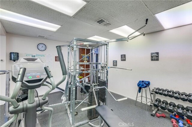 workout area with a paneled ceiling