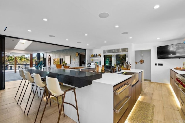 5455 Toyon Rd, San Diego, CA 92115 - kitchen with built in fridge, a spacious island, recessed lighting, light wood finished floors, and a sink