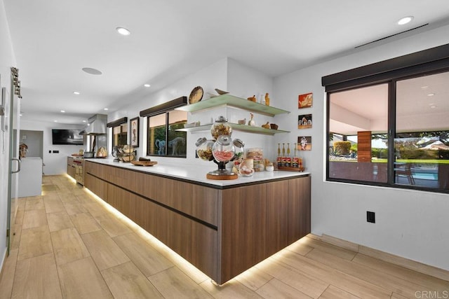 5455 Toyon Rd, San Diego, CA 92115 - kitchen with light wood-style flooring, modern cabinets, exhaust hood, open shelves, and light countertops