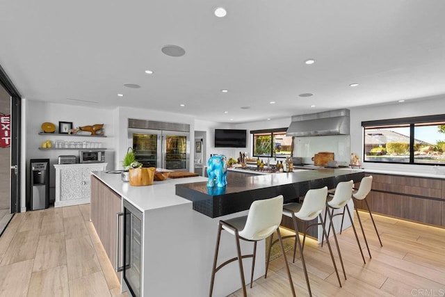 5455 Toyon Rd, San Diego, CA 92115 - kitchen with built in refrigerator, wall chimney exhaust hood, wine cooler, modern cabinets, and a spacious island