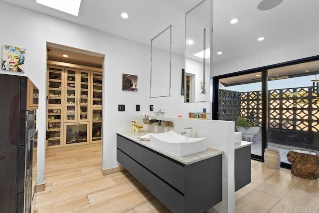 5455 Toyon Rd, San Diego, CA 92115 - full bath featuring vanity, wood finished floors, recessed lighting, and a skylight