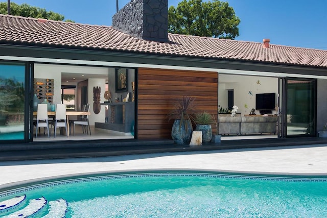 5455 Toyon Rd, San Diego, CA 92115 - back of house featuring a tile roof, an outdoor pool, and a chimney