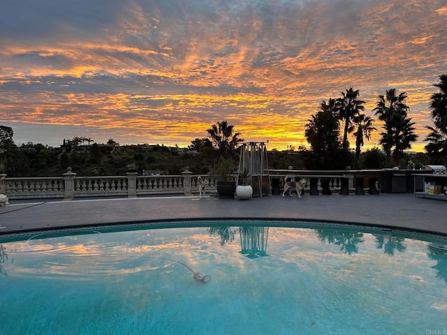 5455 Toyon Rd, San Diego, CA 92115 - pool at dusk with an outdoor pool and a patio