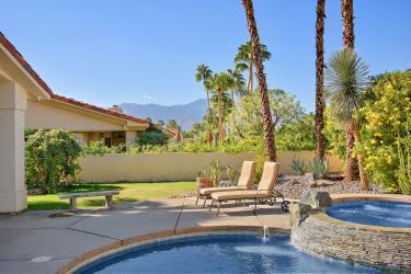 view of pool featuring an in ground hot tub, a mountain view, and a patio