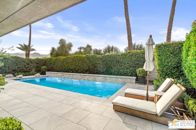 view of pool featuring a patio and pool water feature