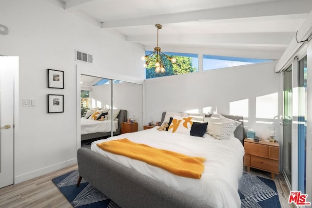 bedroom featuring light wood-type flooring, an inviting chandelier, multiple windows, and lofted ceiling with beams