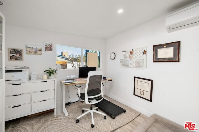 office featuring light wood-type flooring and an AC wall unit