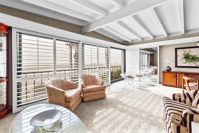 sunroom / solarium featuring vaulted ceiling with beams